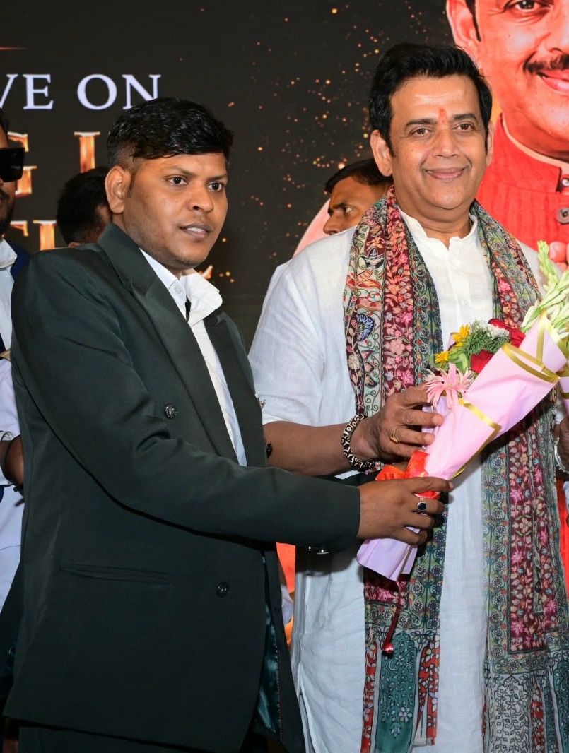 Dr. Santosh Kumar Verma presenting a bouquet at an event